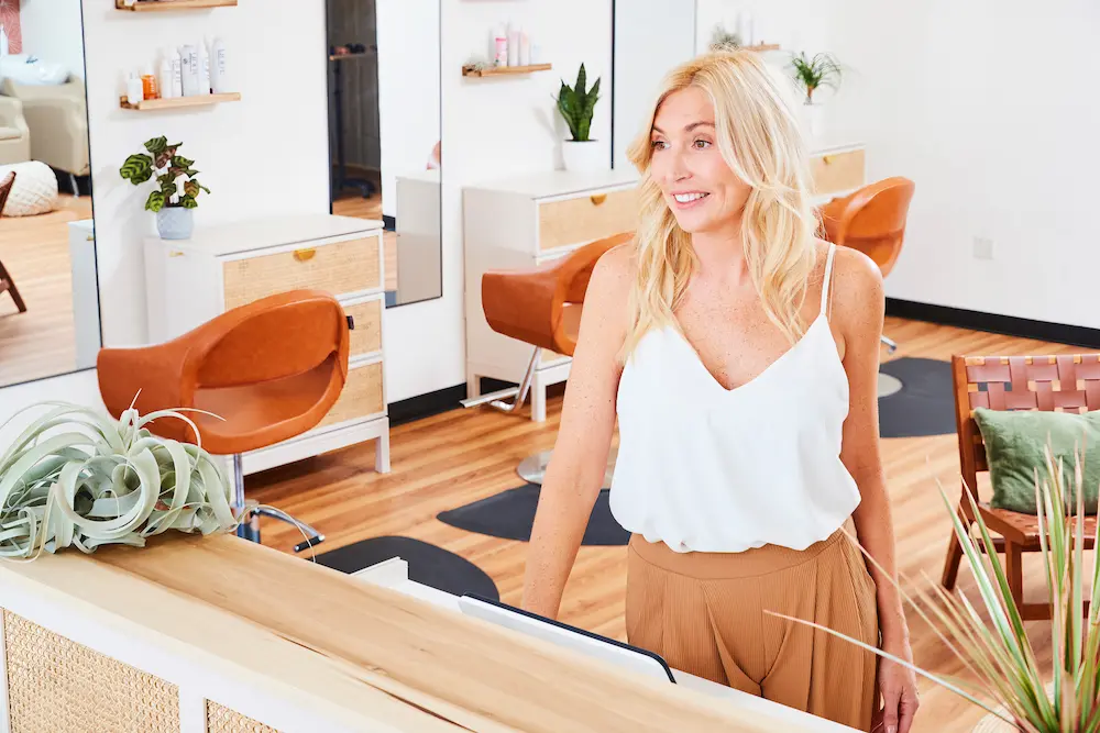 A hairstylist cutting a woman's hair